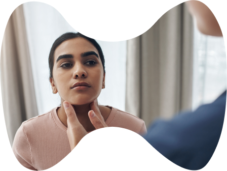 The doctor examines a patient's upper neck for endocrine gland issues.