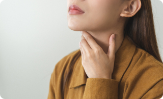 A young female patient self-examining for thyroid.