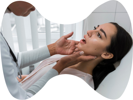A doctor examines a patient for thyroid issues.